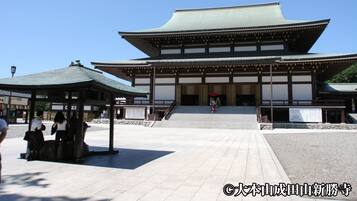 A traditional Japanese building with a large entrance and a covered walkway.