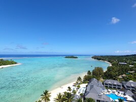 A resort with a pool, beach, and ocean views.