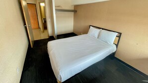A hotel room with a single bed, a door, and a small closet. - Residence & Conference Centre - Ottawa West (Ottawa)
