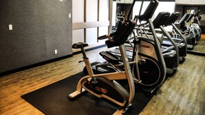 A gym with multiple treadmills, exercise bikes, and a mirrored wall. - Residence & Conference Centre - Kitchener Waterloo (Kitchener)