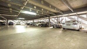 A multi-level underground parking garage with several cars parked. - Oaks Auckland Hotel (Auckland)