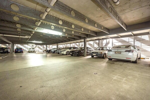 A multi-level underground parking garage with several cars parked. - Oaks Auckland Hotel (Auckland)