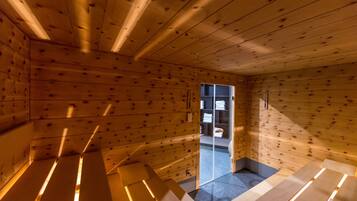 Un intérieur en bois avec un banc, une porte donnant sur l’extérieur et une petite table.