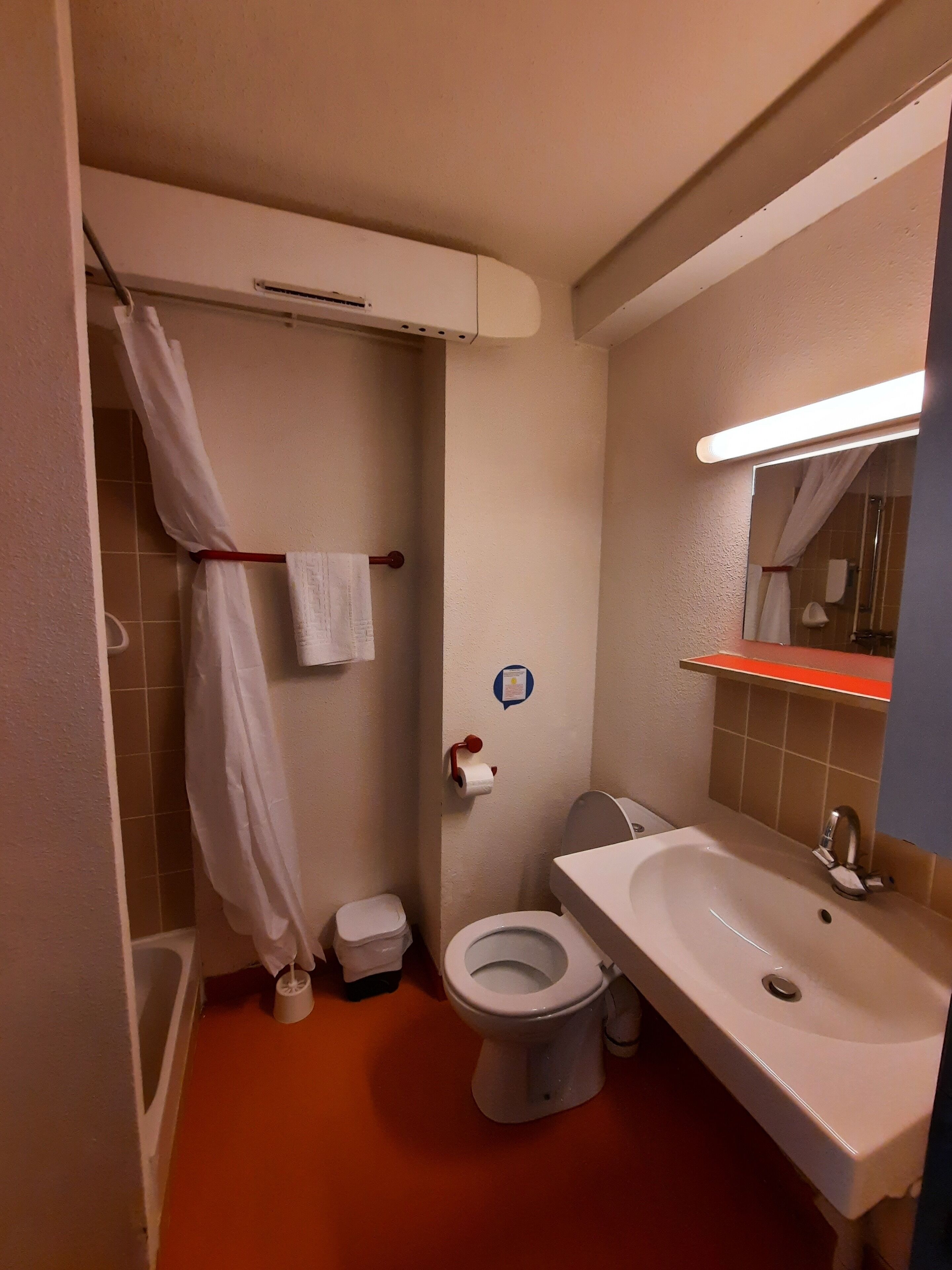 A bathroom with a toilet, sink, and shower.