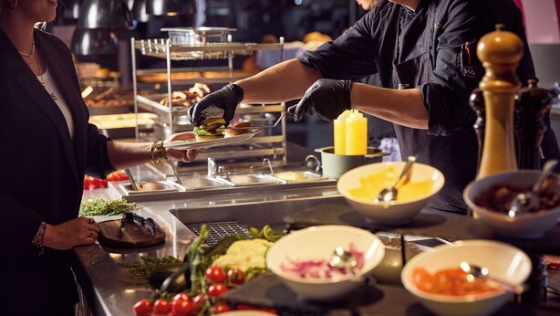 A buffet setup with various food items and condiments. - Van Der Valk Hotel Amersfoort A1 (Amersfoort)