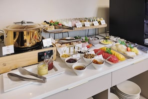 A buffet setup with various food items and condiments. - Hotel Unicus Krakow Old Town - Destigo Hotels (Kraków)