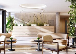 A modern lobby with a reception desk, seating area, and decorative plants. - Botanique Hotel Prague (Prague)