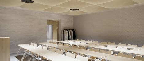 A conference room with multiple tables and chairs, a wardrobe, and a door.