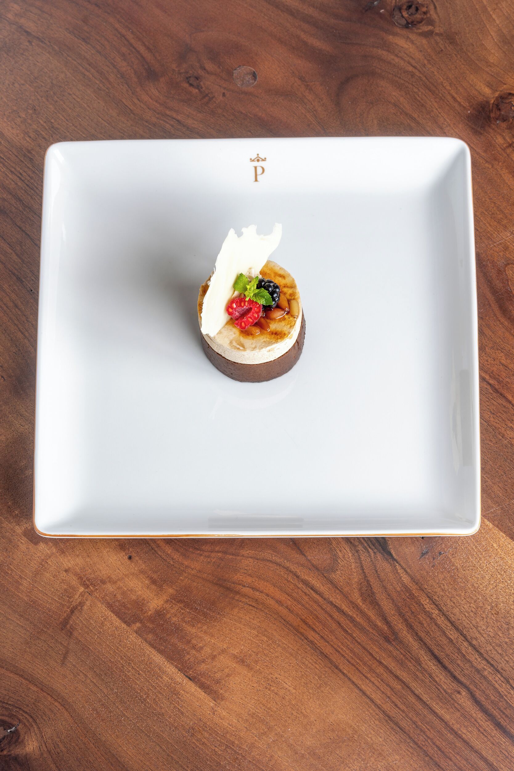 A white rectangular plate with a dessert on a wooden table.