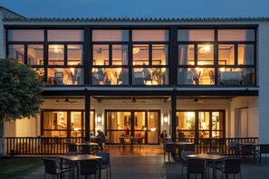 A two-story building with an outdoor patio area. - Parador De Mazagon (Moguer)