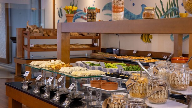 A buffet with various food items and condiments.