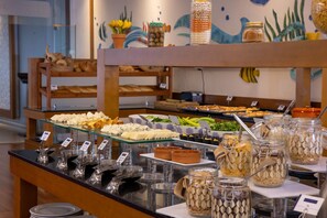 A buffet with various food items and condiments.