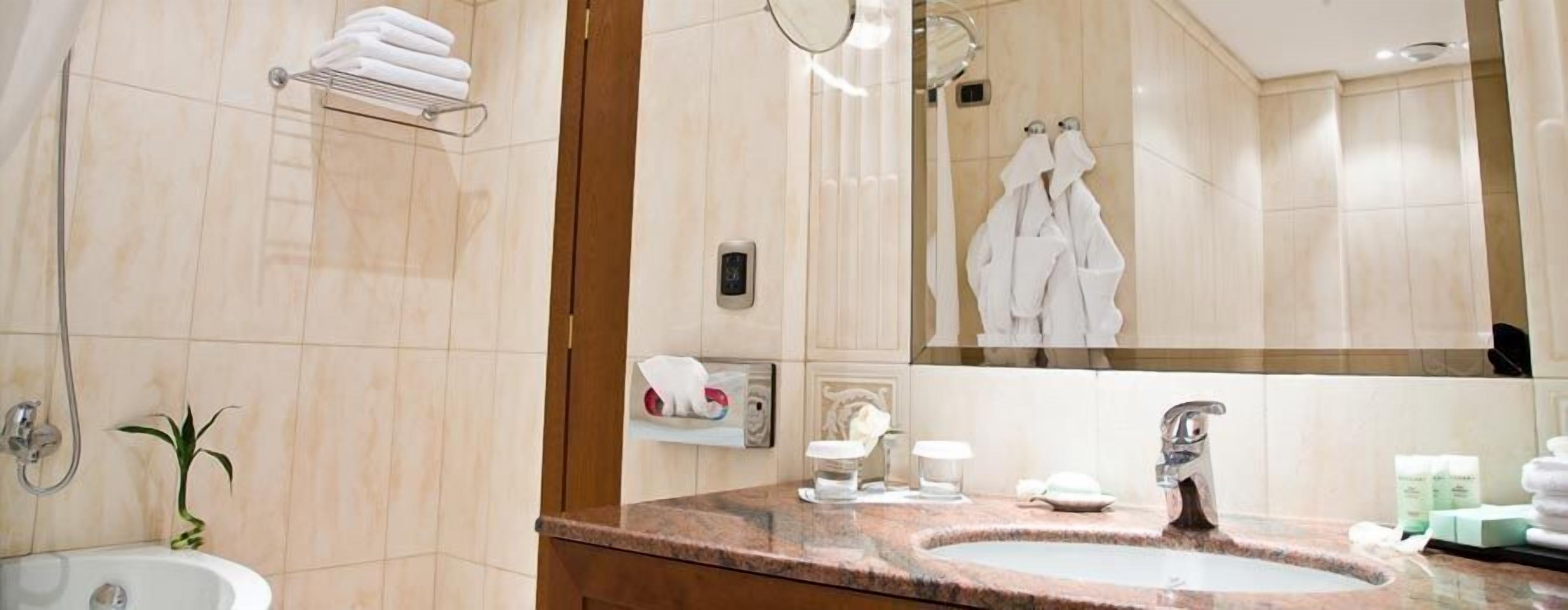 designer toiletries, hair dryer, bathrobes, slippers