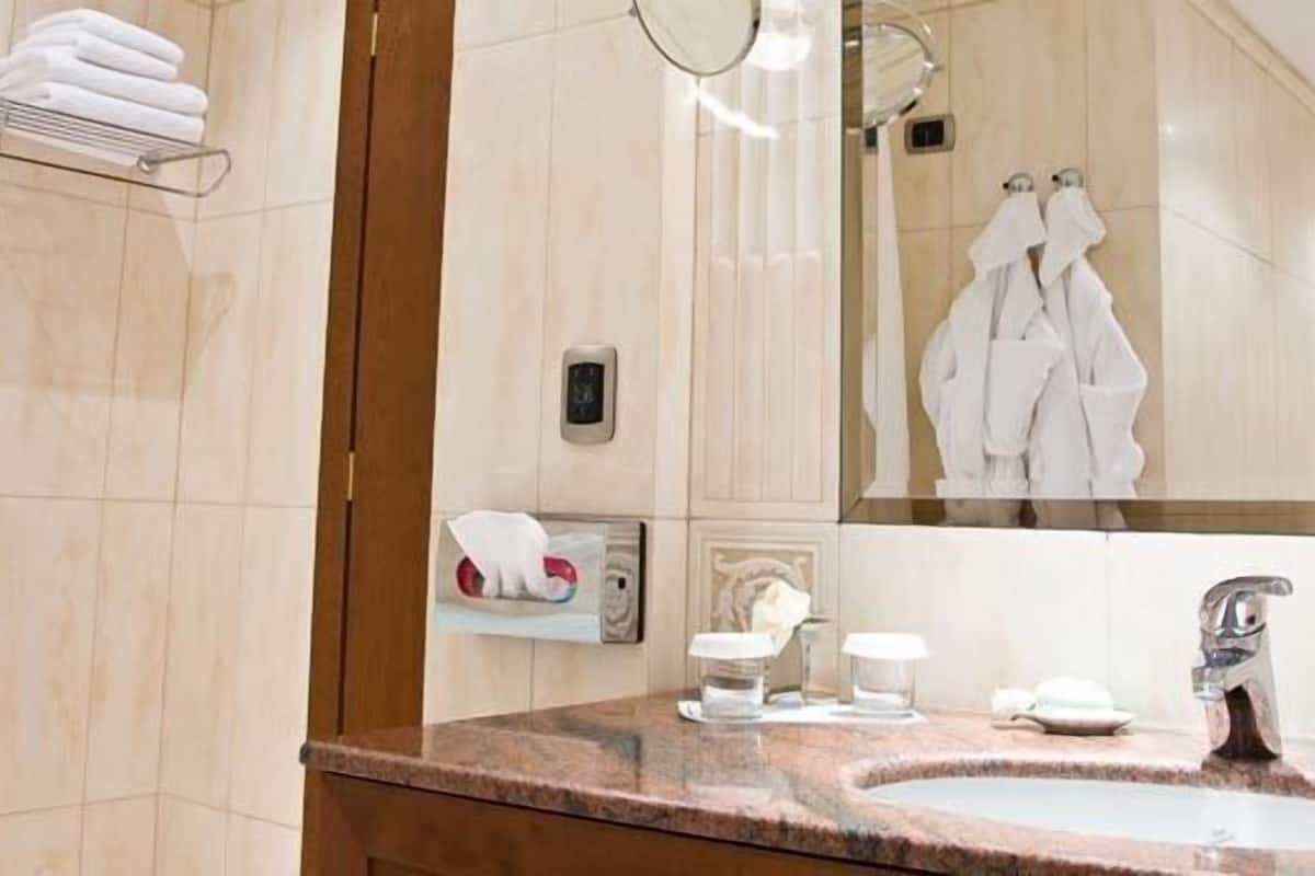 designer toiletries, hair dryer, bathrobes, slippers