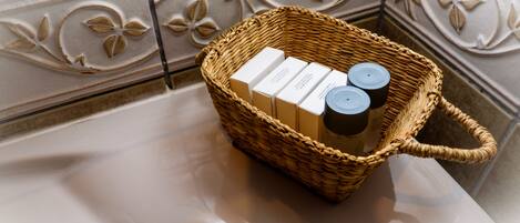 A wicker basket with toiletries on a bathroom counter.