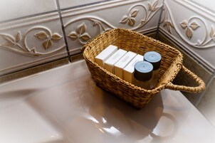 A wicker basket with toiletries on a bathroom counter.