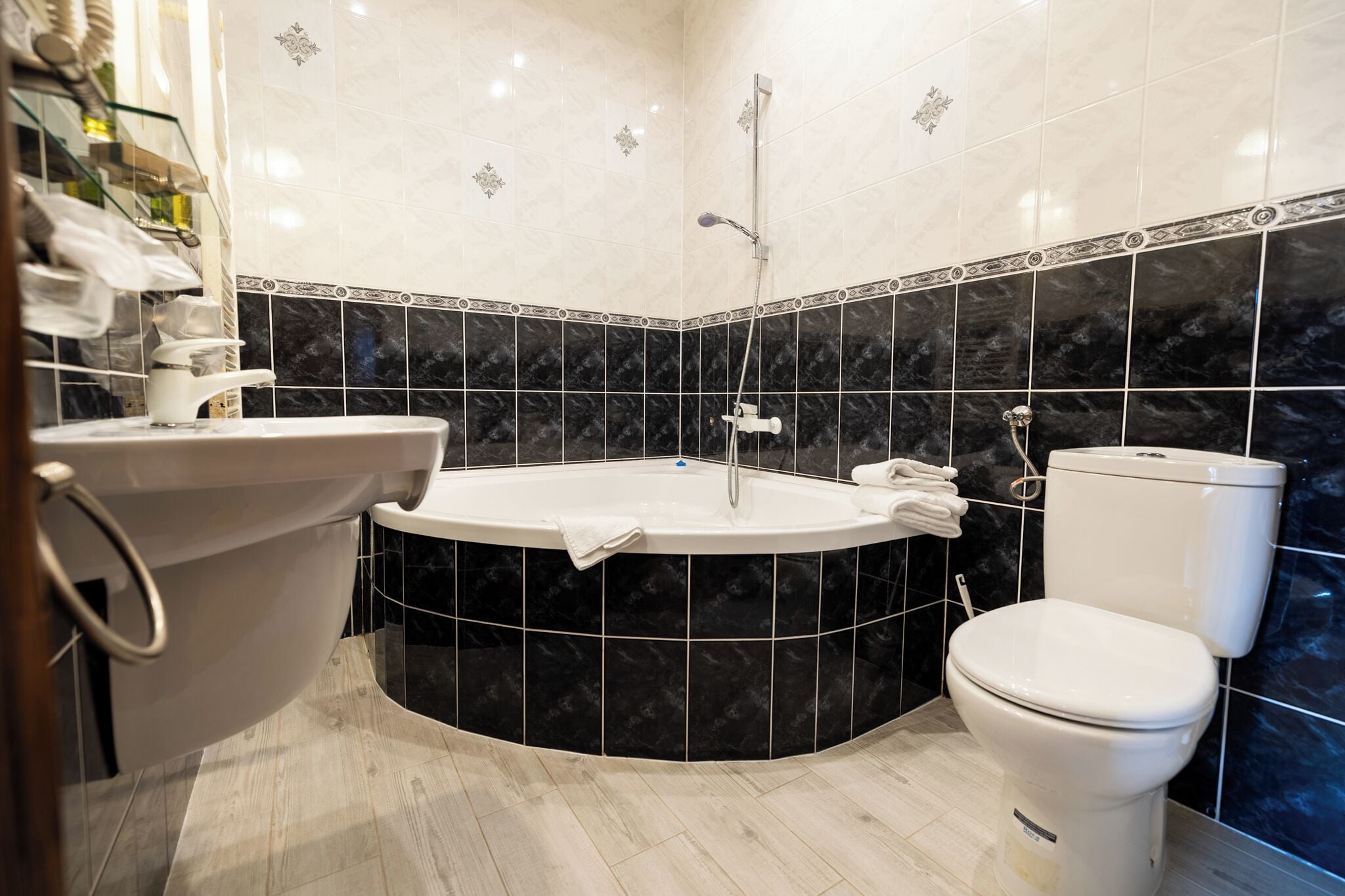 A bathroom with a freestanding bathtub, a toilet, and a sink.