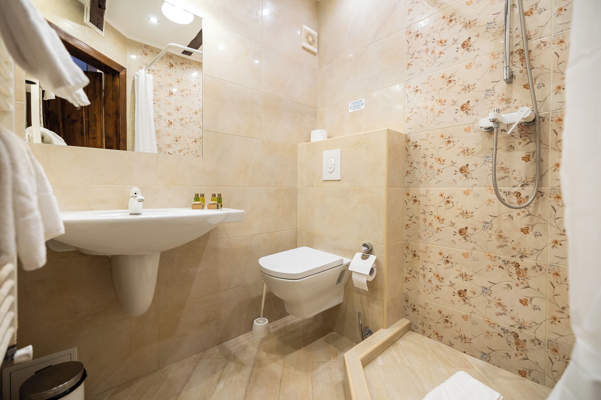 A bathroom with a sink, toilet, and shower.