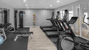 A modern gym with treadmills, weight machines, and dumbbells. - Homewood Suites by Hilton Fayetteville (Fayetteville)