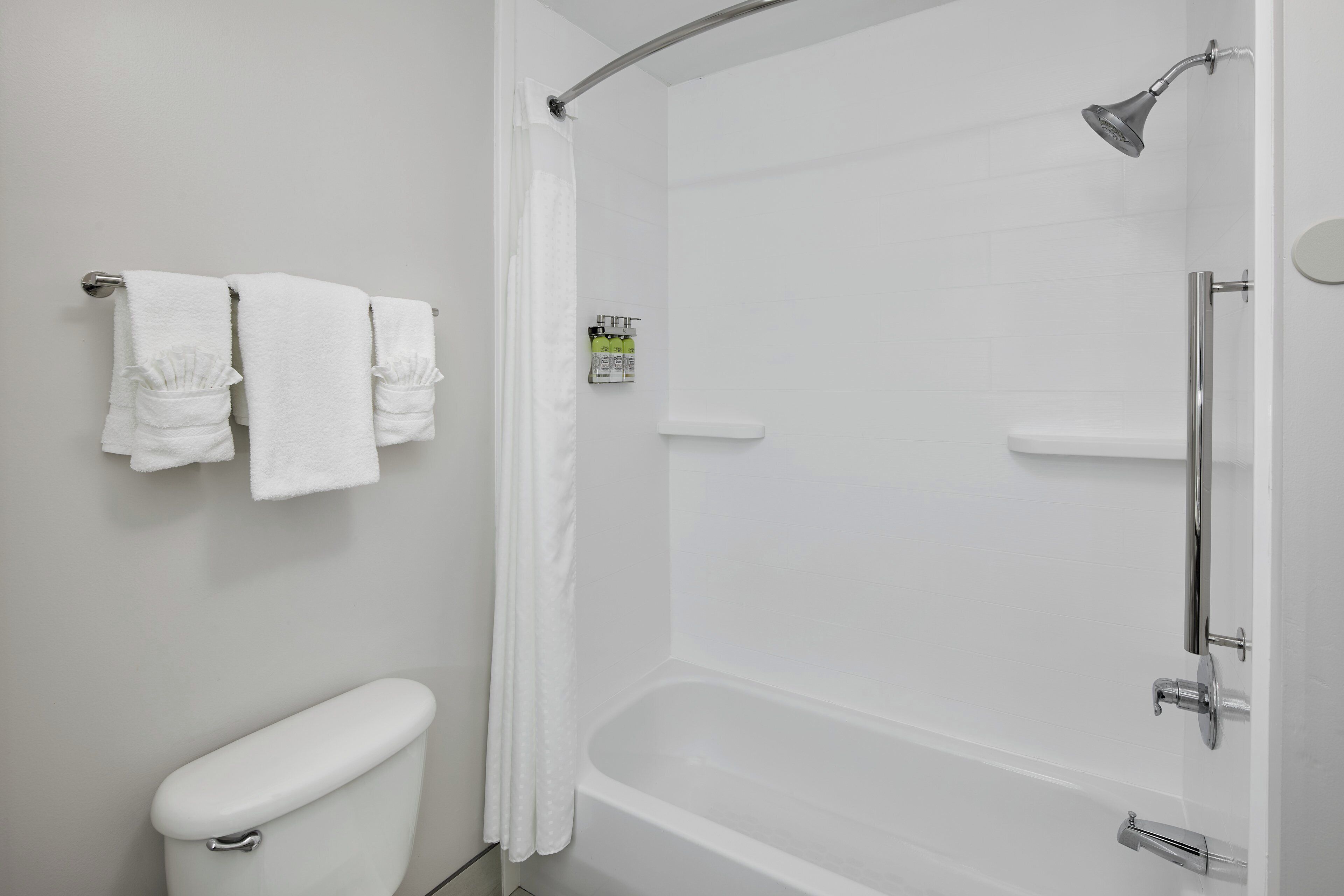 A bathroom with a toilet, a shower, and a bathtub.