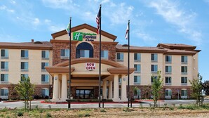 A Holiday Inn Express & Suites hotel with a 'NOW OPEN' sign, multiple floors, and a brick facade. - Holiday Inn Express Hotel & Suites FRESNO NORTHWEST-HERNDON by IHG (Fresno)