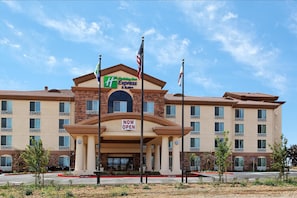 A Holiday Inn Express & Suites hotel with a 'NOW OPEN' sign, multiple floors, and a brick facade. - Holiday Inn Express Hotel & Suites FRESNO NORTHWEST-HERNDON by IHG (Fresno)