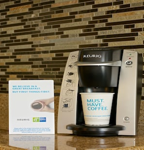 Une machine à café Keurig, une tasse de café et une enseigne Holiday Inn Express.