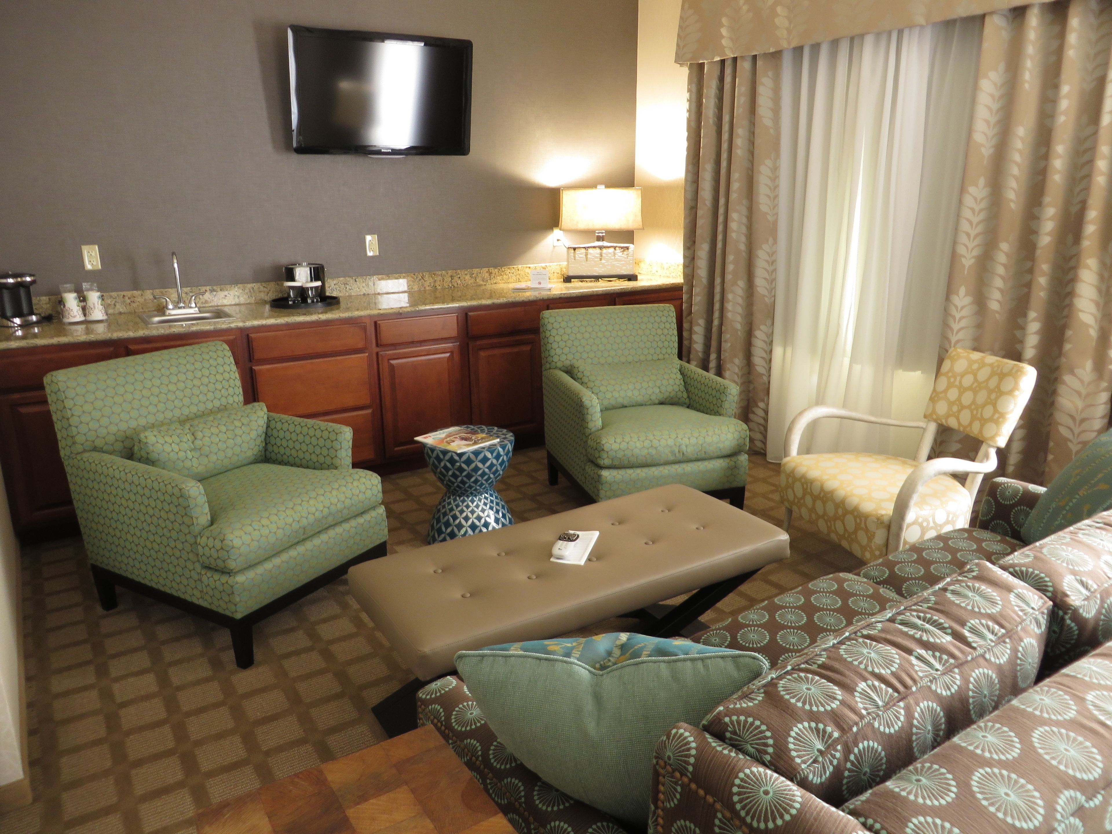 premier suite with 1 king bed & a sleeper sofa | living area | 40-inch led tv with satellite channels, tv, ipod dock