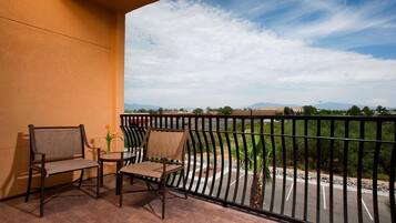 Premium bedding, desk, laptop workspace, blackout drapes