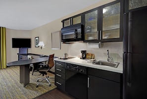 A compact kitchen with a microwave, coffee maker, and a sink. - Candlewood Suites Sumter by IHG (Sumter)
