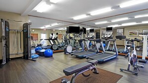 A gym with treadmills, elliptical machines, and free weights. - Candlewood Suites Sumter by IHG (Sumter)