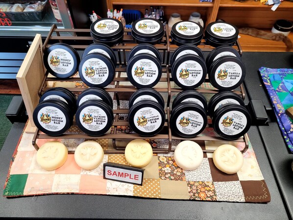 A display of various Johnny's lotion bars in a store.