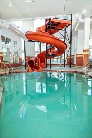 An indoor swimming pool with a multi-level water slide. - Service Plus Inns and Suites Calgary (Calgary)