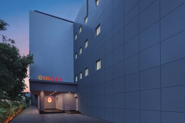 A modern building with a flat facade, a visible entrance, and a sign that reads "GINGER". - Ginger Vadodara (Vadodara)