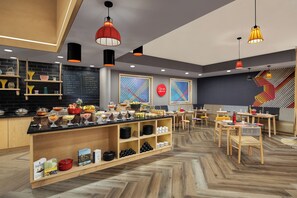 A modern restaurant with a wooden counter, black menu board, and colorful wall art. - Ginger Vadodara (Vadodara)