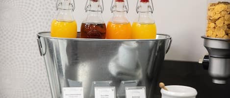 A beverage dispenser with four different drinks, a cereal container, and a coffee maker.
