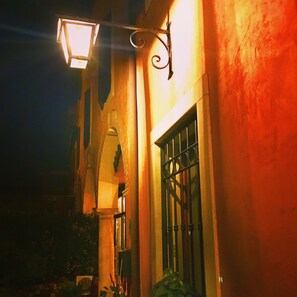 A building with a barred window and a hanging light fixture.