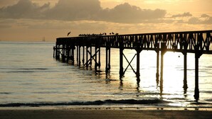 A pier extending into calm waters at sunset. - Hotel Beau Soleil (Cesenatico)