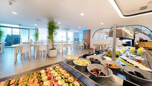 A buffet with various food items and a seating area with tables and chairs. - Servatur Alameda de Jandía (Pajara)