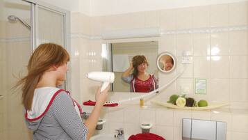 A bathroom with a sink, mirror, and a towel rack.