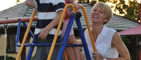 A playground with a blue and yellow ladder structure.