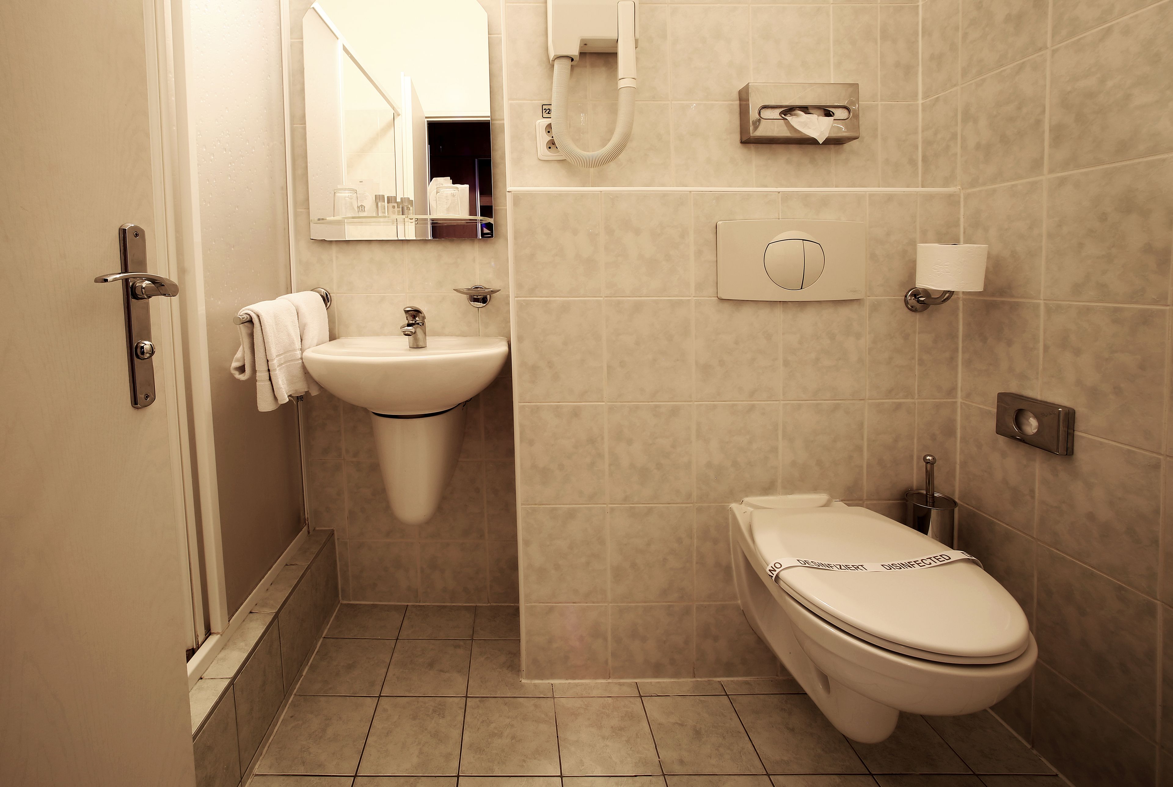 A bathroom with a sink, toilet, and shower.