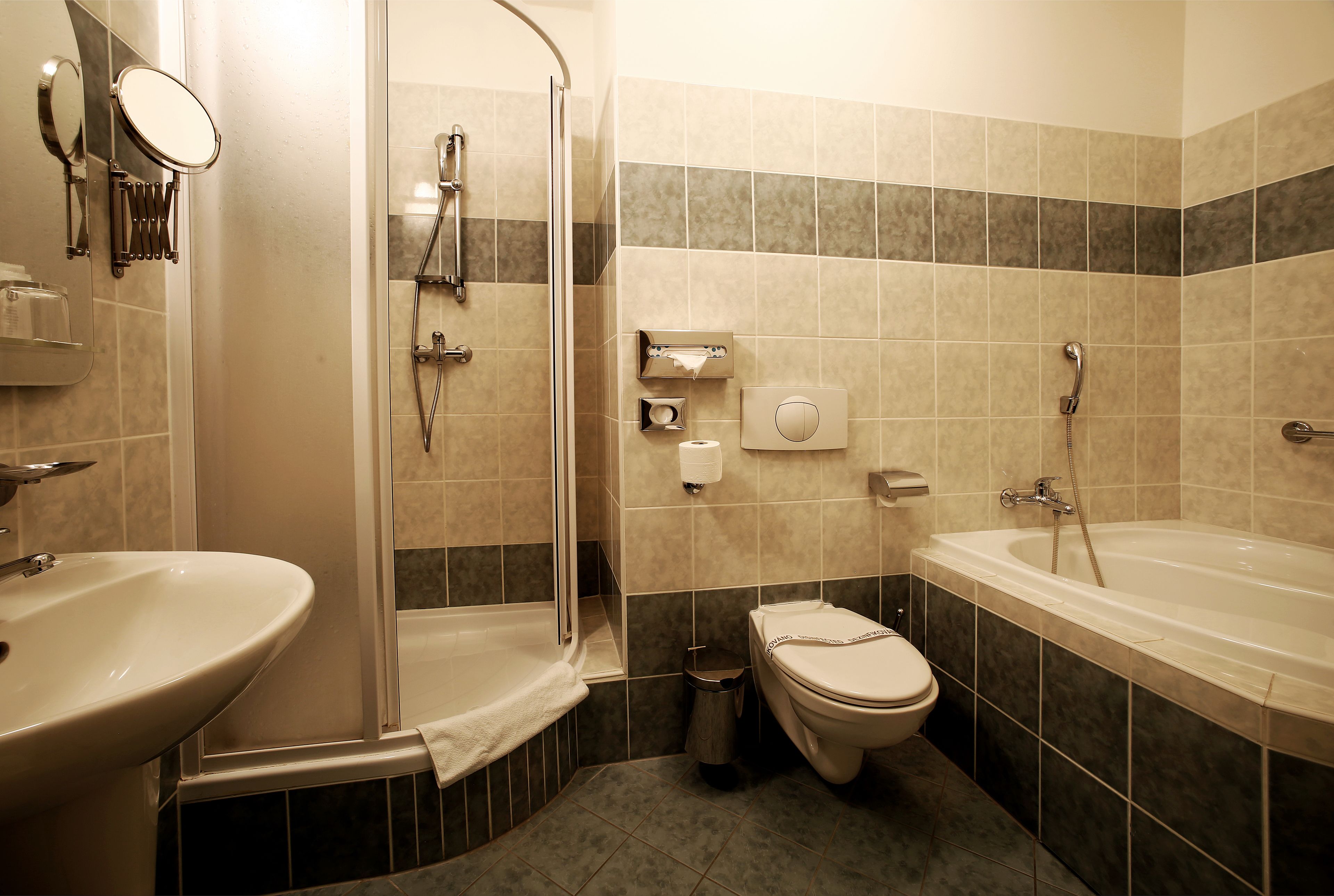 A bathroom with a sink, toilet, shower, and bathtub.
