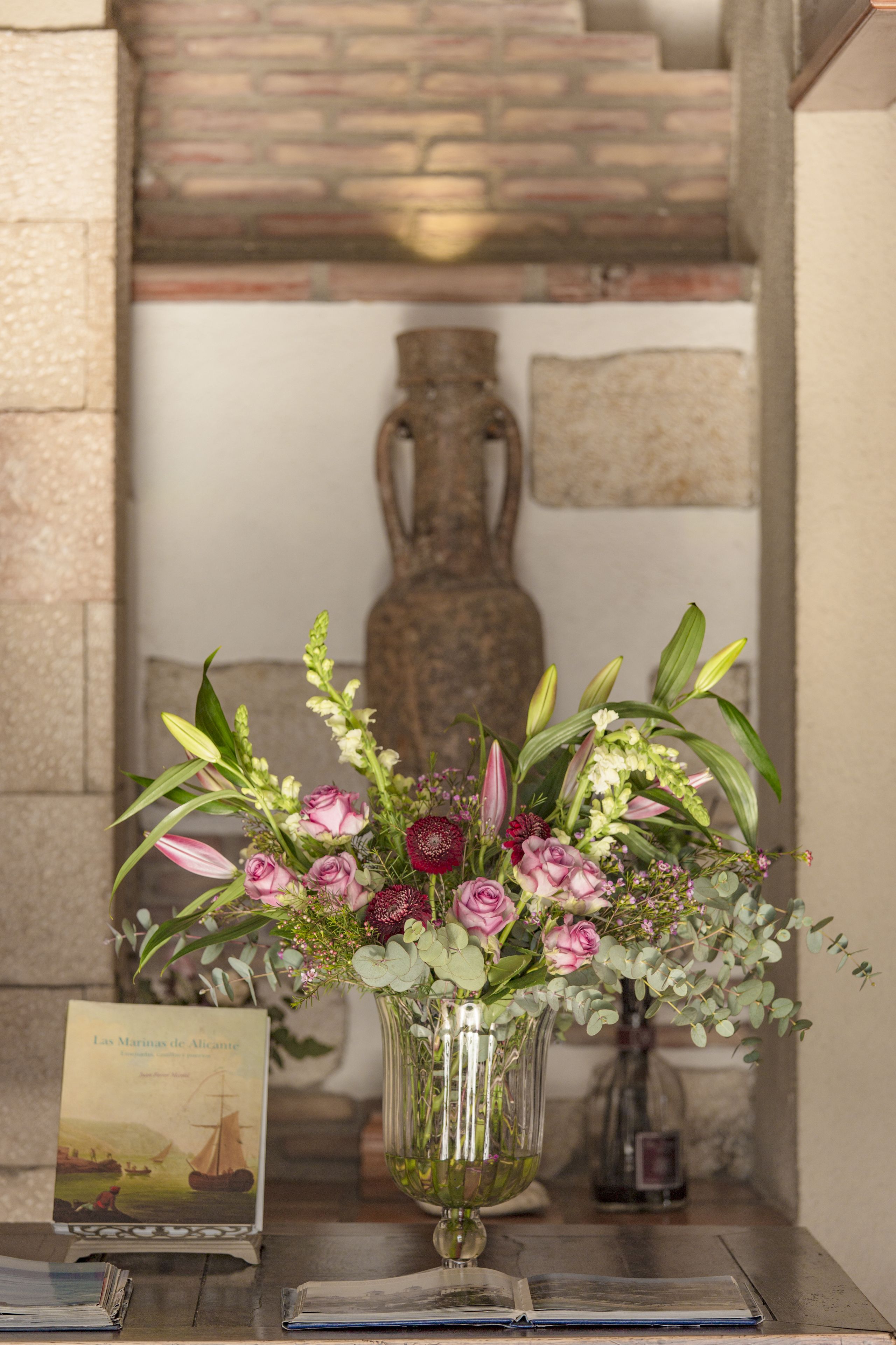 A clear view of a room with a wooden table, a vase with flowers, and a book.