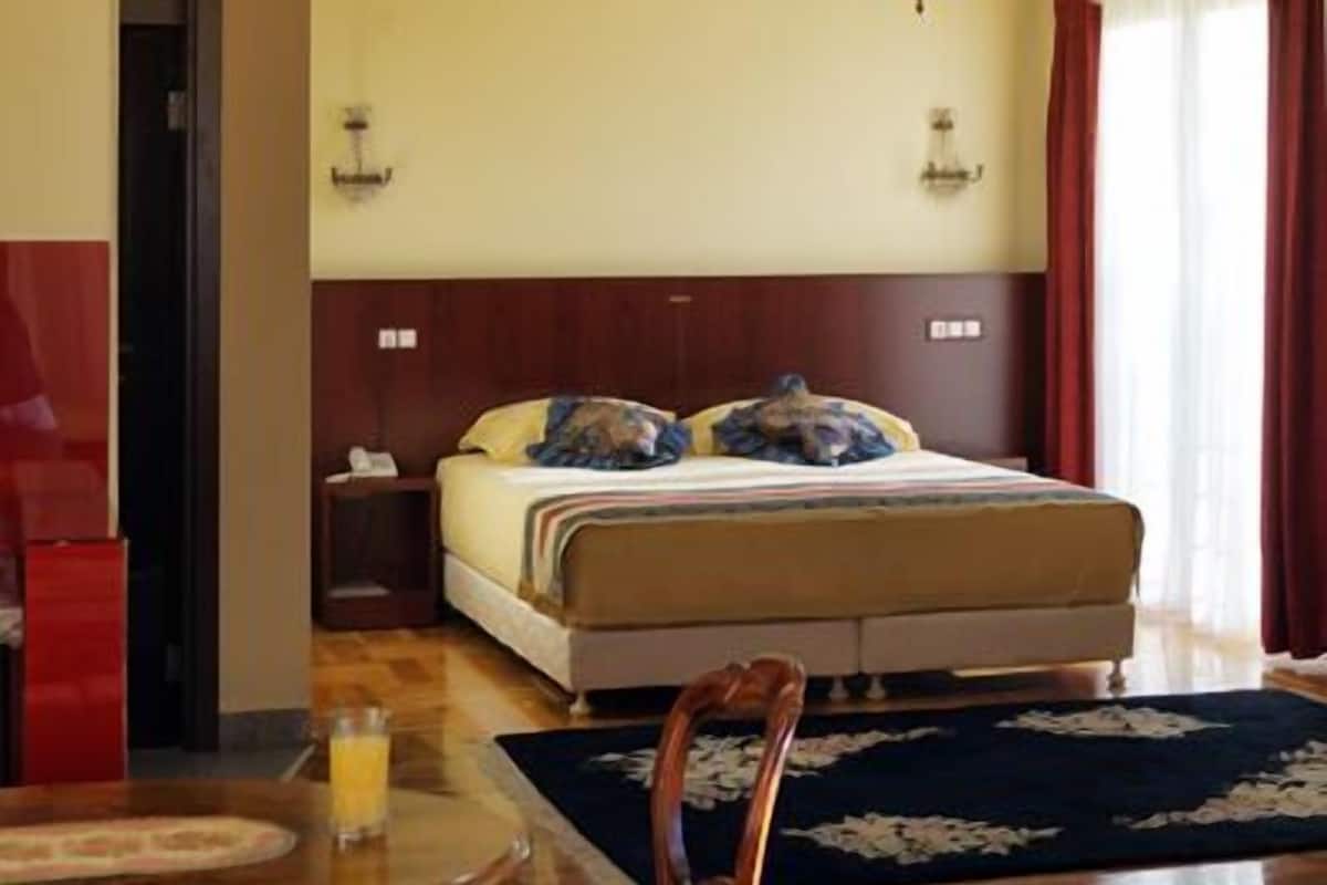 superior room, multiple beds, courtyard view | living area | tv, dvd player