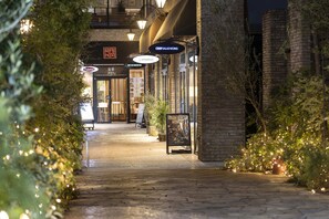 A nighttime street view with a restaurant named "Crisp Salad Works" and another called "Hitochachi." - Tokyu Stay Aoyama Premier (Tokyo)