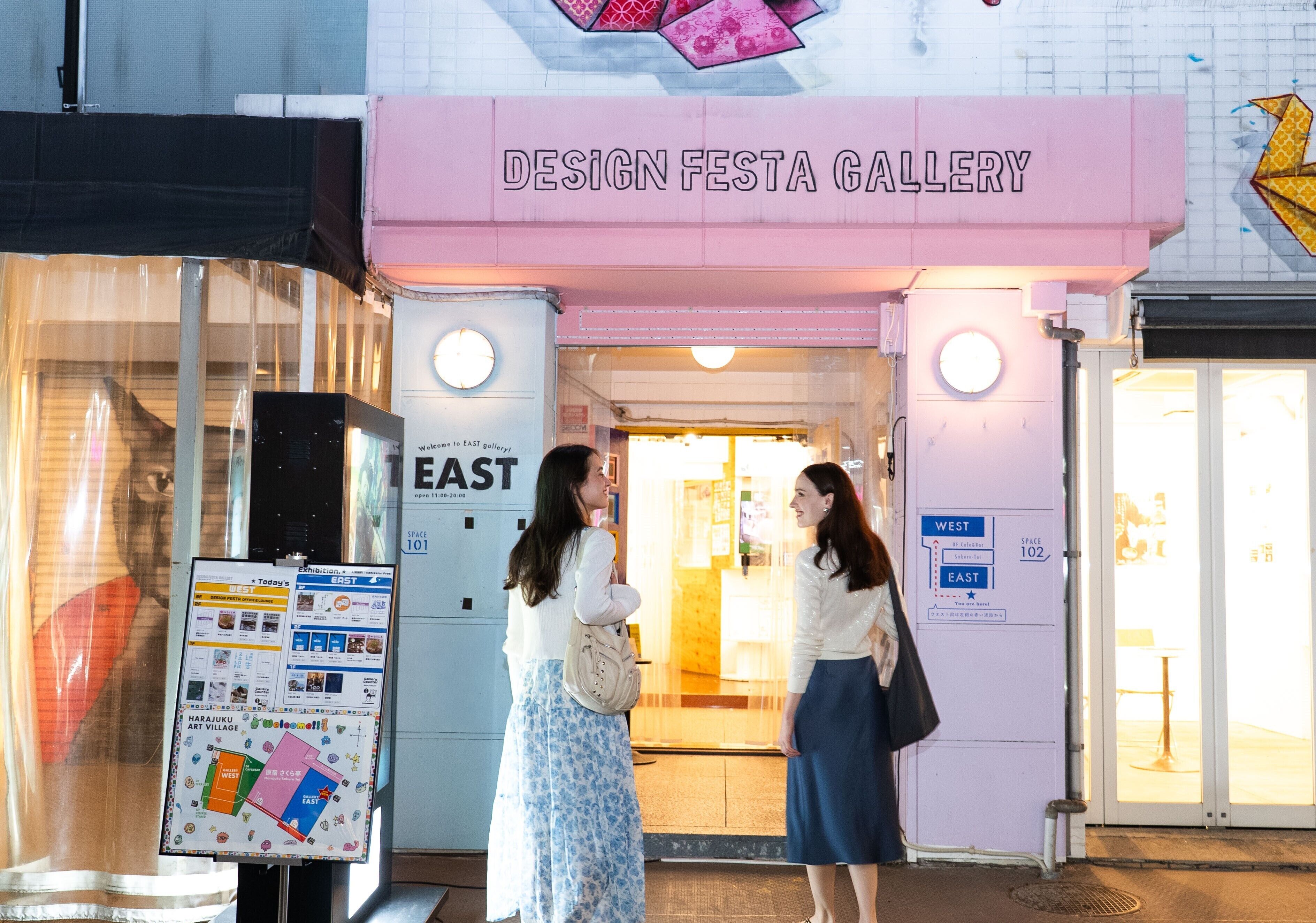 The entrance to Design Festa Gallery with directional signs to East and West spaces.