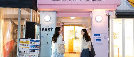 The entrance to Design Festa Gallery with directional signs to East and West spaces.