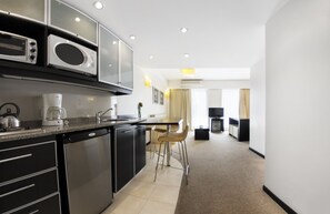 Fridge, microwave, coffee/tea maker, cookware/dishes/utensils