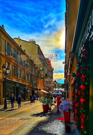 Stroll through charming streets lined with traditional European-style buildings, featuring balconies and awnings.